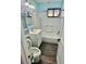 Updated bathroom with light blue walls, white tub, and wood-look flooring at 1608 Briarcliff Ne Rd # 3, Atlanta, GA 30306