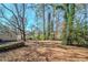 Large backyard with mature trees and a stone retaining wall at 3388 Jackson Dr, Decatur, GA 30032