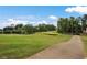 Landscaped golf course with walking path and pond at 490 Birkdale Dr, Fayetteville, GA 30215