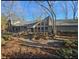 Gray house with large windows, deck, and stone walkway, nestled in a wooded area at 190 Valley Cv, Atlanta, GA 30350