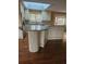 Kitchen with granite island, white cabinets, and hardwood floors at 190 Valley Cv, Atlanta, GA 30350