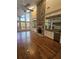 Spacious living room with hardwood floors, stone fireplace, and built-in wet bar at 190 Valley Cv, Atlanta, GA 30350
