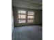 Empty spare bedroom with new gray carpet and windows at 190 Valley Cv, Atlanta, GA 30350