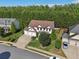 Aerial view of a spacious home featuring a well-maintained lawn, mature trees, and a three-car garage at 334 Spotted Ridge Cir, Woodstock, GA 30188