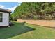 Landscaped backyard with retaining wall and fence at 334 Spotted Ridge Cir, Woodstock, GA 30188