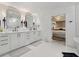 Stylish bathroom featuring double sinks, herringbone-patterned floor, and a chandelier-lit bedroom entrance at 334 Spotted Ridge Cir, Woodstock, GA 30188