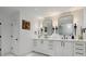 Elegant bathroom with double vanity, marble countertops, patterned backsplash, and modern fixtures at 334 Spotted Ridge Cir, Woodstock, GA 30188