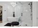 A luxury bathroom featuring a chandelier, glass shower, soaking tub and a stool at 334 Spotted Ridge Cir, Woodstock, GA 30188