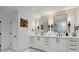 The bathroom boasts dual sinks, sconces, and a decorative tile accent wall at 334 Spotted Ridge Cir, Woodstock, GA 30188