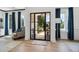 Bright entryway with a modern glass door and hardwood floors at 334 Spotted Ridge Cir, Woodstock, GA 30188