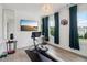 This exercise room has a rower and scenic views through large windows at 334 Spotted Ridge Cir, Woodstock, GA 30188
