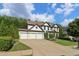 Beautiful two-story home with a three-car garage, manicured lawn, and mature landscaping at 334 Spotted Ridge Cir, Woodstock, GA 30188