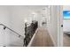 Well-lit hallway with wood floors, ornate railings, and an open view to an adjacent hallway at 334 Spotted Ridge Cir, Woodstock, GA 30188