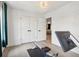 Bright home gym room with white doors and inspirational writing on the wall behind a modern rowing machine at 334 Spotted Ridge Cir, Woodstock, GA 30188