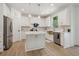 White kitchen with a large island, marble countertops, and gold accents at 334 Spotted Ridge Cir, Woodstock, GA 30188