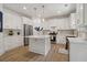 Modern kitchen with white cabinets, marble island, and stainless steel appliances at 334 Spotted Ridge Cir, Woodstock, GA 30188