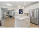 Open kitchen with white cabinets, marble countertops, and a large island at 334 Spotted Ridge Cir, Woodstock, GA 30188