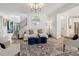 Bright living room features hardwood floors, white walls, and a comfortable sofa at 334 Spotted Ridge Cir, Woodstock, GA 30188