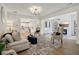 Open living room with hardwood floors, neutral color palette, and stylish furniture at 334 Spotted Ridge Cir, Woodstock, GA 30188