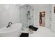 Luxurious main bath showcasing a stand-alone tub, glass-enclosed shower, and walk-in closet access at 334 Spotted Ridge Cir, Woodstock, GA 30188