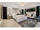 Luxurious main bedroom with a large bed, stylish seating, and a dramatic chandelier at 334 Spotted Ridge Cir, Woodstock, GA 30188