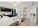 Bright main bedroom showcasing a chandelier, an accent chair, and an adjacent bathroom and hallway at 334 Spotted Ridge Cir, Woodstock, GA 30188