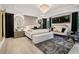 Luxurious primary bedroom with hardwood floors, chandelier lighting, and stylish decor at 334 Spotted Ridge Cir, Woodstock, GA 30188