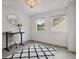 Inviting bright office space with modern desk, chair, large windows, white walls, and a decorative rug at 334 Spotted Ridge Cir, Woodstock, GA 30188