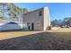 Tan house with backyard, grass, and patio at 7618 Mcgillicuty Dr, Union City, GA 30291