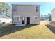 Tan house with backyard, grass, and patio at 7618 Mcgillicuty Dr, Union City, GA 30291