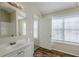 Bathroom with vanity, large window and door to bedroom at 7618 Mcgillicuty Dr, Union City, GA 30291