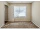Well-lit bedroom with carpet, window, and door to hallway at 7618 Mcgillicuty Dr, Union City, GA 30291