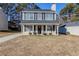 Two-story house with gray roof, beige siding, and black shutters at 7618 Mcgillicuty Dr, Union City, GA 30291