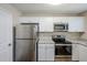 Modern kitchen featuring stainless steel appliances and white cabinets at 7618 Mcgillicuty Dr, Union City, GA 30291