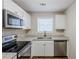 Modern kitchen with granite countertops and stainless steel appliances at 7618 Mcgillicuty Dr, Union City, GA 30291