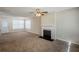 Spacious living room with fireplace and ceiling fan at 7618 Mcgillicuty Dr, Union City, GA 30291