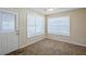 Bright bedroom with large windows and neutral carpeting at 7618 Mcgillicuty Dr, Union City, GA 30291