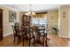 Formal dining room with glass-top table and hardwood floors at 2650 The Terraces Way, Dacula, GA 30019