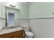 Small bathroom with granite countertop, wood vanity, and beadboard wainscot at 2691 Willow Green Dr, Duluth, GA 30096