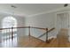 Second floor hallway featuring hardwood floors and an arched window at 2691 Willow Green Dr, Duluth, GA 30096