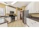 Kitchen with white cabinets, stainless steel appliances, and tile floor at 2983 Rosebrook Dr, Decatur, GA 30033