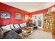 Red-walled living room features a sectional sofa and hardwood floors at 514 Waterside Ct, Canton, GA 30114