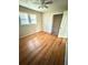 Cozy bedroom featuring hardwood floors, closet, and bright window at 869 Meadow Rock Way, Stone Mountain, GA 30083