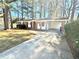 Charming brick home with a covered carport and a well-maintained front yard and a concrete driveway at 869 Meadow Rock Way, Stone Mountain, GA 30083