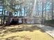 Cozy brick home featuring a covered carport and a spacious front yard, perfect for outdoor activities at 869 Meadow Rock Way, Stone Mountain, GA 30083