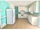 Updated kitchen with white cabinets, tile flooring, and modern appliances, perfect for culinary enthusiasts at 869 Meadow Rock Way, Stone Mountain, GA 30083
