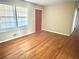 Bright living room with hardwood floors, large windows, and a cozy atmosphere for relaxation and entertainment at 869 Meadow Rock Way, Stone Mountain, GA 30083