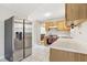 Kitchen features stainless steel refrigerator and wood cabinets at 707 Stonemill Mnr, Lithonia, GA 30058