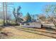 Sloped backyard with a view of the house and surrounding trees at 2756 Plantation Dr, East Point, GA 30344