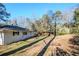 View of the backyard, showing a sloped lawn and surrounding houses at 2756 Plantation Dr, East Point, GA 30344